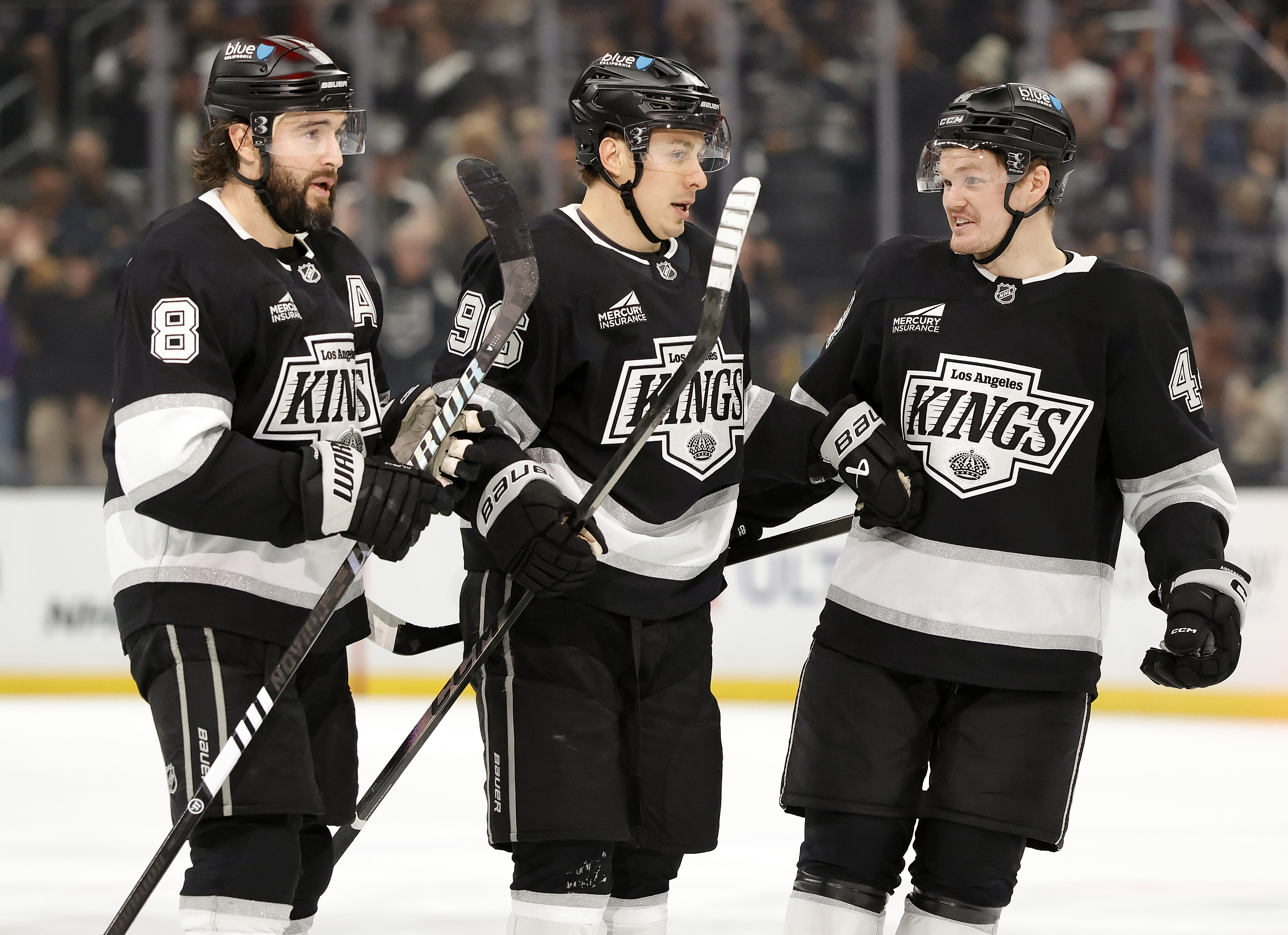 The Kings’ Drew Doughty, left, Andrei Kuzmenko, center, and Mikey...