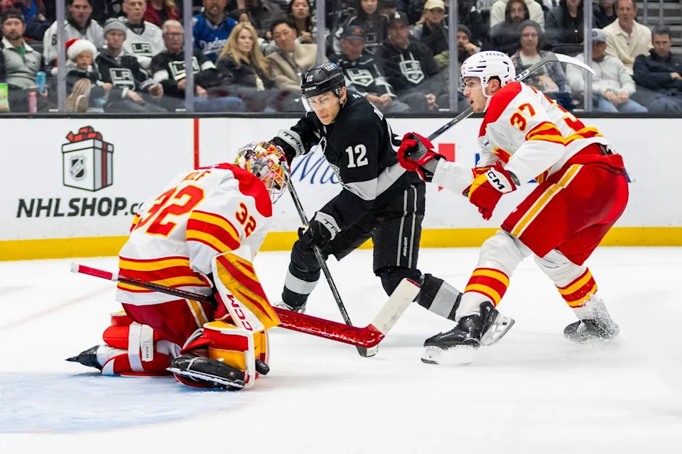 Goaltender Dustin Wolf #32 of the Calgary Flames makes a save against left wing Trevor Moore #12 of the Los Angeles Kings during an NHL hockey game, Saturday December 13, 2025 in Los Angeles, Calif.