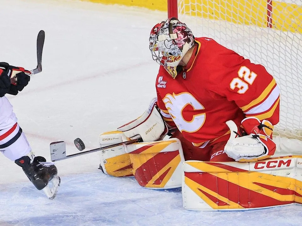 Calgary Flames goalie Dustin Wolf stops this scoring chance by Chicago Blackhawks forward Tyler Bertuzzi at the Scotiabank Saddledome in Calgary on November 7, 2025.