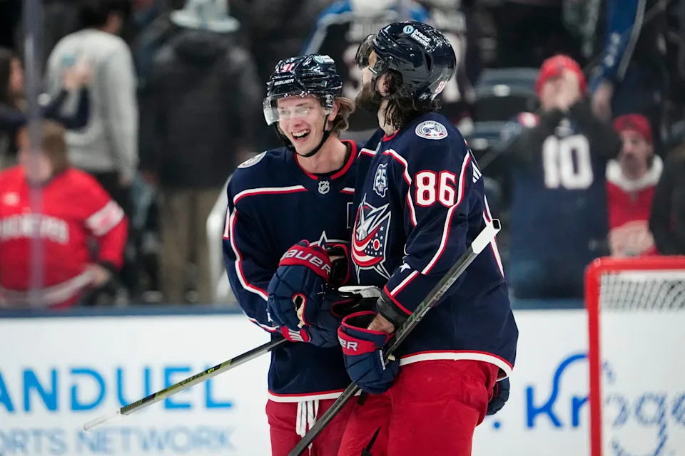 Blue Jackets right wing Kirill Marchenko (86) and center Kent Johnson celebrate following a win over the Red Wings on Dec. 4.