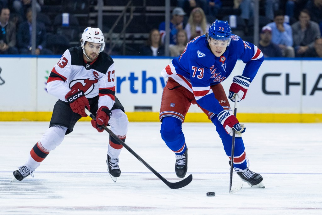 New Jersey Devils center Nico Hischier (13) pursues New York Rangers center Matt Rempe (73) in the first period at Madison Square Garden, Thursday, Oct. 2, 2025, in New York, NY. 