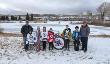 Kemmerer Mayor Robert Bowen and some members of the Kemmerer Hockey League stand near the bleachers with the pond in the background. Pictured are Mayor Bowen, Preston Nelson, Maddox Seamon, Paizlee Nelson, Graham Calkins, Beth Calkins, Grayson Seamon and Adam Calkins.