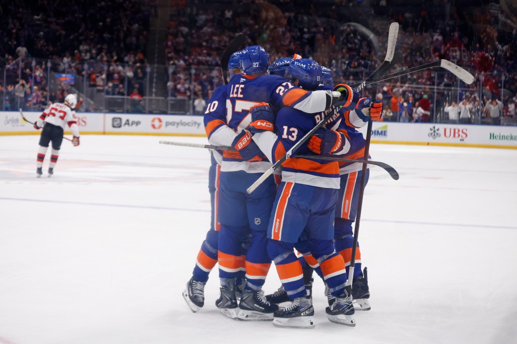 New York Islanders defenseman Adam Pelech (3) celebrates with his teammates after he scores the game winning goal during the third period when the New York Islanders played the New Jersey Devils Tuesday, December 23, 2025 at UBS Arena in Elmont, NY.