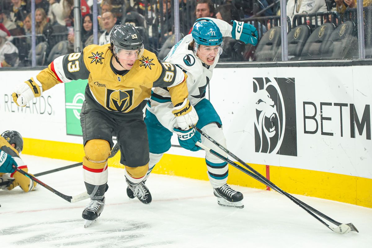 Vegas Golden Knights F Mitch Marner (93) and San Jose Sharks F Macklin Celebrini (71) fight for puck possession during an NHL game on Tuesday December 23, 2025, in Las Vegas, Nevada. 