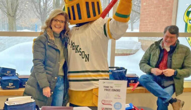 Pictured from left are Rae Hitchman, Potsdam Chamber of Commerce board member; the Clarkson Golden Knight mascot; and Rick Hitchman during the Potsdam Chamber of Commerce&rsquo;s annual Chamber Hockey Night at Cheel Arena.