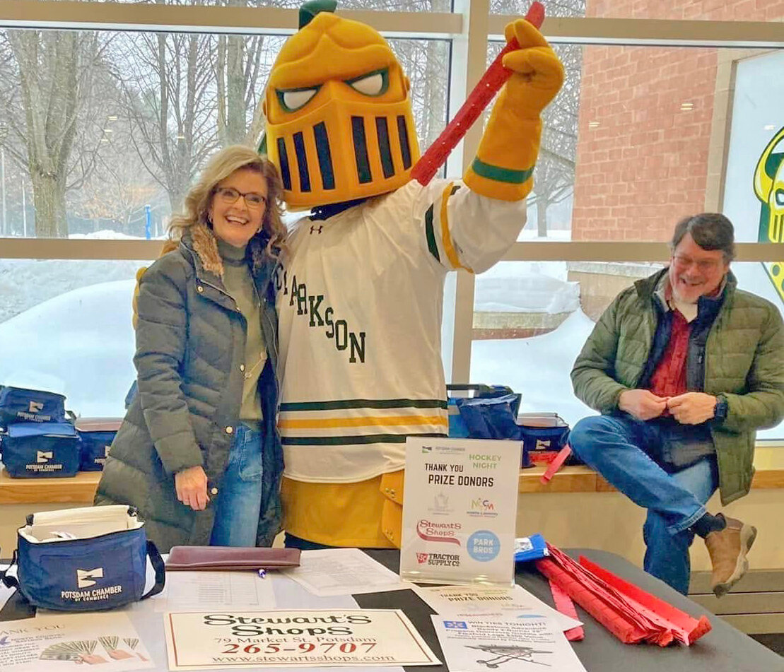 Pictured from left are Rae Hitchman, Potsdam Chamber of Commerce board member; the Clarkson Golden Knight mascot; and Rick Hitchman during the Potsdam Chamber of Commerce&rsquo;s annual Chamber Hockey Night at Cheel Arena.