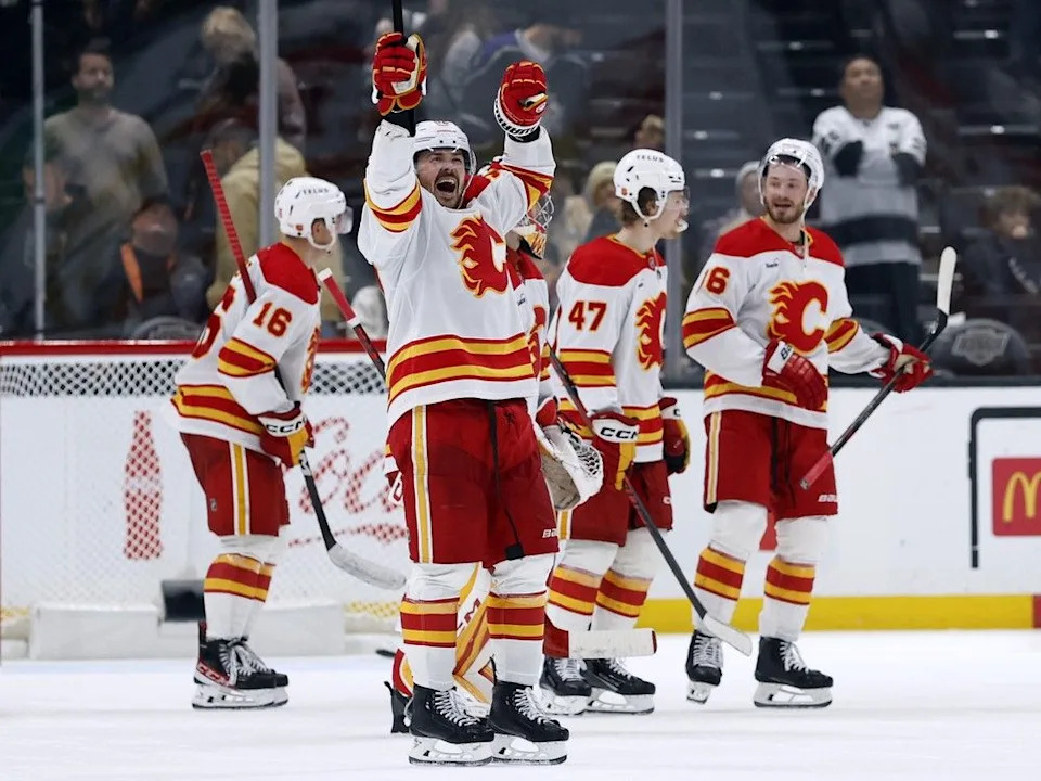  Mackenzie Weegar and Flames teammates celebrate their win.