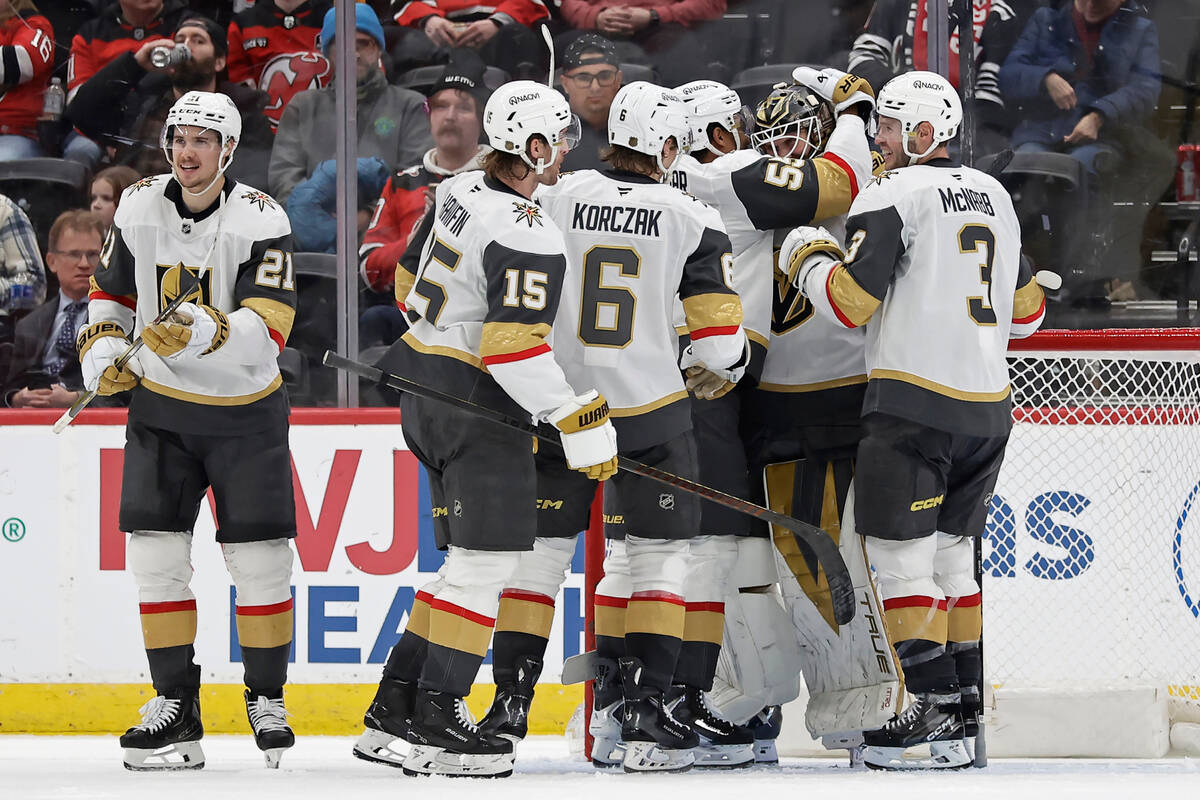 Vegas Golden Knights goaltender Akira Schmid, second from right, is congratulated by teammates ...