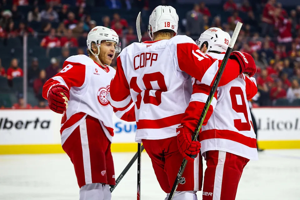 Detroit Red Wings right wing Alex Debrincat (93) celebrates his goal with teammates against the Calgary Flames during the first period at Scotiabank Saddledome in Calgary, Alberta, on Wednesday, Dec. 10.
