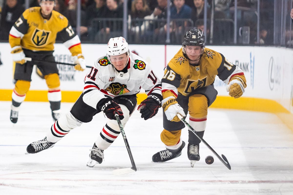 Chicago Blackhawks center Oliver Moore (11) and Vegas Golden Knights right wing Pavel Dorofeyev (16) both go after a loose puck during a NHL game between the Vegas Golden Knights and the Chicago Blackhawks, Tuesday December 2, 2025 in Las Vegas, Nev.