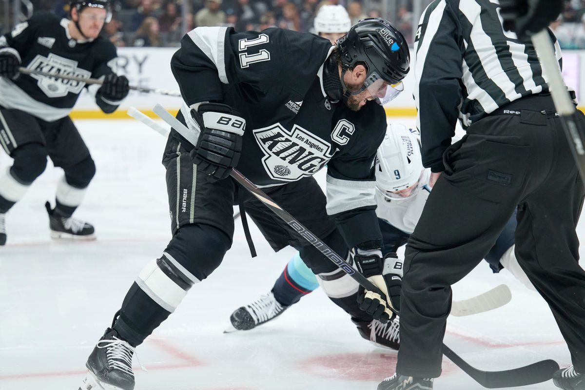 Los Angeles Kings center Anze Kopitar (11) fights for the puck against the Kraken at the crypto.com Arena on December 23,2025 in Los Angeles, California.