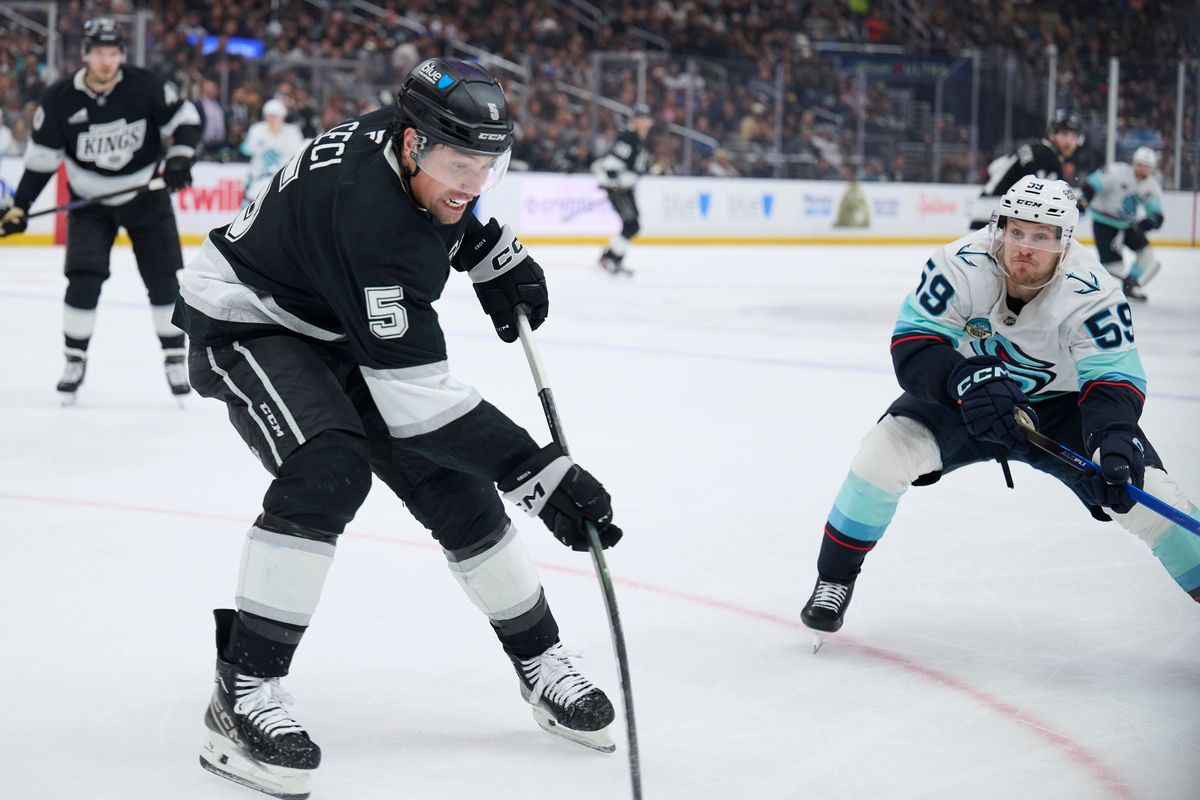 Los Angeles Kings defenseman Cody Ceci (5) clears the puck against the Kraken at the crypto.com Arena on December 23,2025 in Los Angeles, California.
