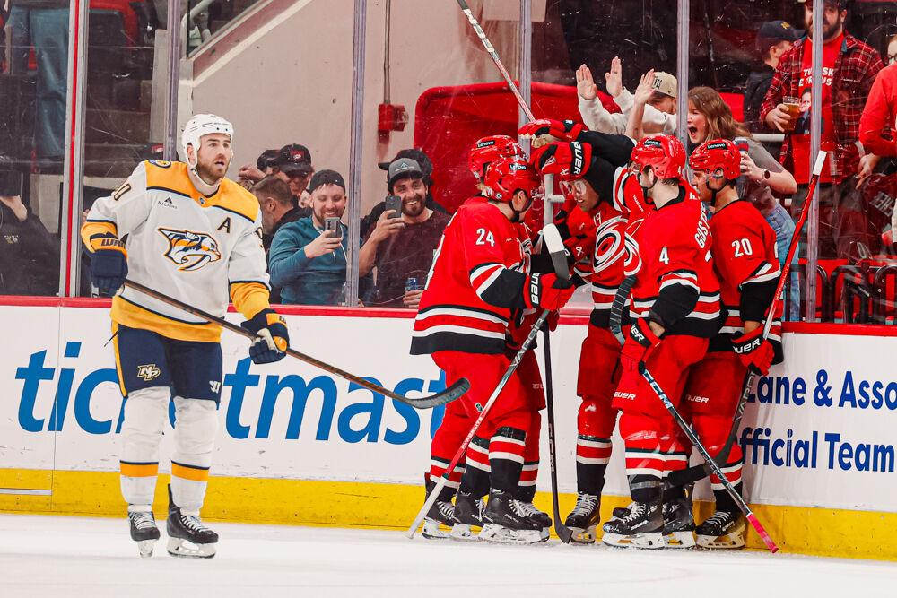 Left wing Taylor Hall celebrates with his teammates after scoring a goal against the Nashville Predators at the Lenovo Center on Tuesday, March 25, 2025. Hall scored his goal during the power-play time period. The Hurricanes lost 3-1.