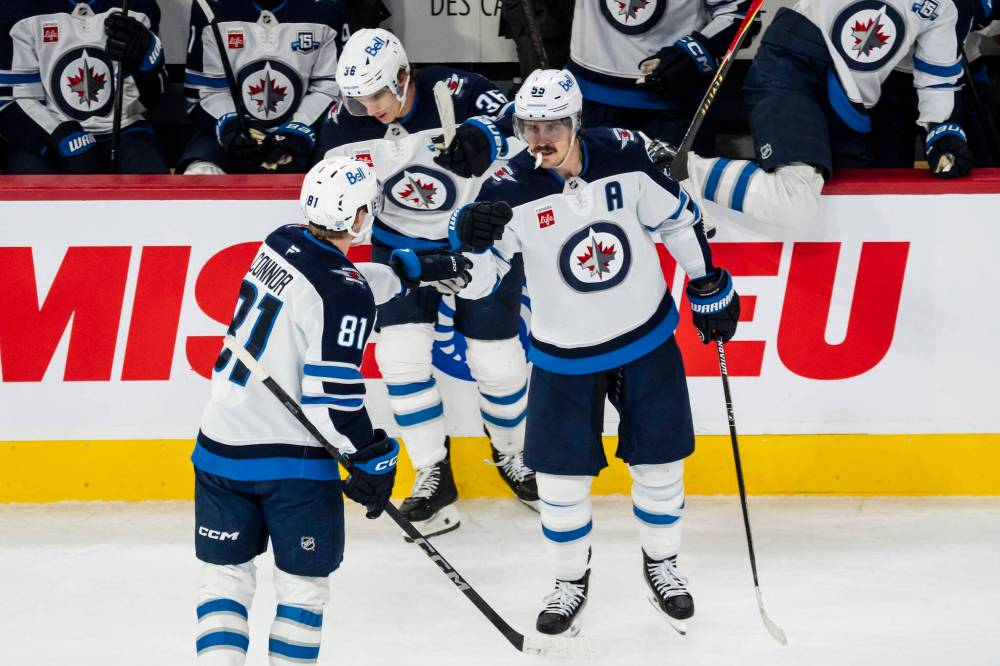 Christopher Katsarov / THE CANADIAN PRESS
The Jets’ Mark Scheifele celebrates his first period goal against the Montreal Canadiens with teammate Kyle Connor Wednesday.