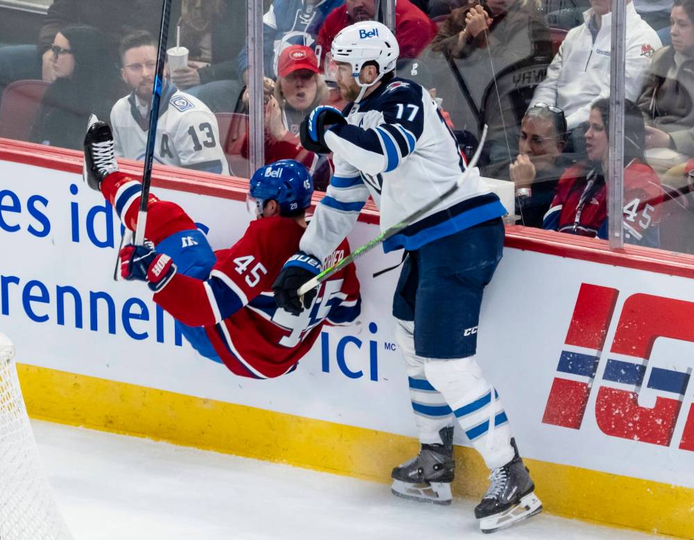 Christopher Katsarov / THE CANADIAN PRESS
Jets captain Adam Lowry got the better of this encounter with the Habs’ Alexandre Carrier on Wednesday night in Montreal.