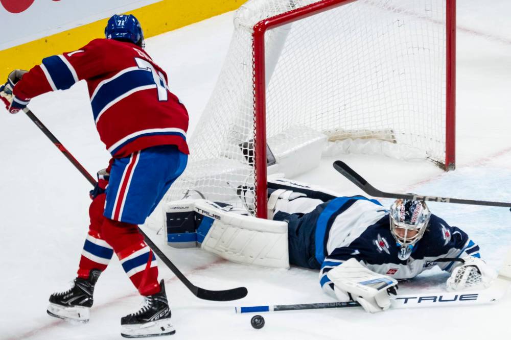 Christopher Katsarov / THE CANADIAN PRESS
Jets goaltender Eric Comrie makes a save on Montreal Canadiens’ Jake Evans in the first period.