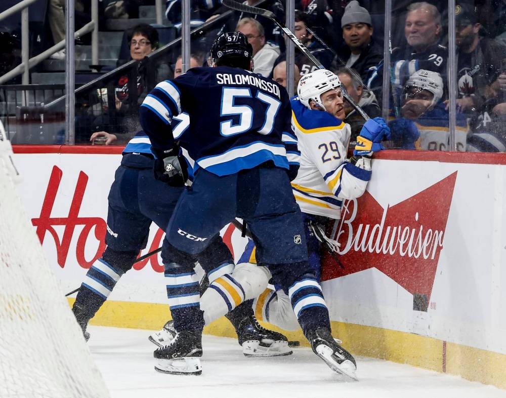 John Woods / THE CANADIAN PRESS
Winnipeg Jets’ Cole Koepke (left hidden) collides with Buffalo Sabres’ Beck Malenstyn (29) as Elias Salomonsson (57) looks on during first period NHL action in Winnipeg on Friday, December 5, 2025.