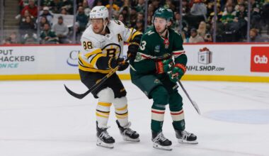 David Pastrnak battles with the Wild's new superstar, Quinn Hughes, in Sunday's Bruins loss in Minnesota.