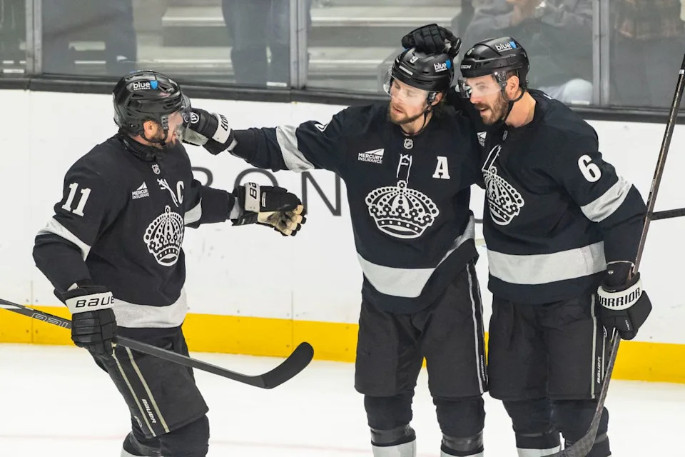 Center Anze Kopitar #11, right wing Adrian Kempe #9, and defenseman Joel Edmundson #6 of the Los Angeles Kings celebrate a goal during an NHL hockey game against the Calgary Flames, Saturday December 13, 2025 in Los Angeles, Calif.
