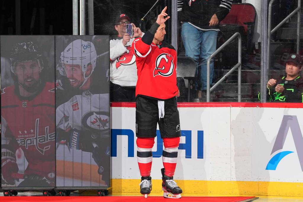 New Jersey Devils defenceman Brenden Dillon greeting the crowd while being honoured for playing his 1000th game in the NHL on Dec. 1, 2025. He achieved this during the New Jersey Devils’ game against the Columbus Blue Jackets. (NHL/New Jersey Devils/X/Twitter)