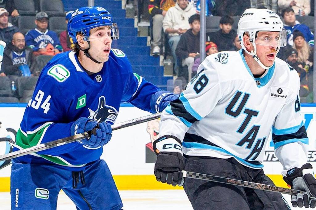 Vancouver Canucks forward Linus Karlsson, left, battles with Utah Mammoth defenceman Nate Schmidt during NHL action Friday, Dec. 5, 2025 at Rogers Arena in Vancouver. (https://x.com/Canucks photo)