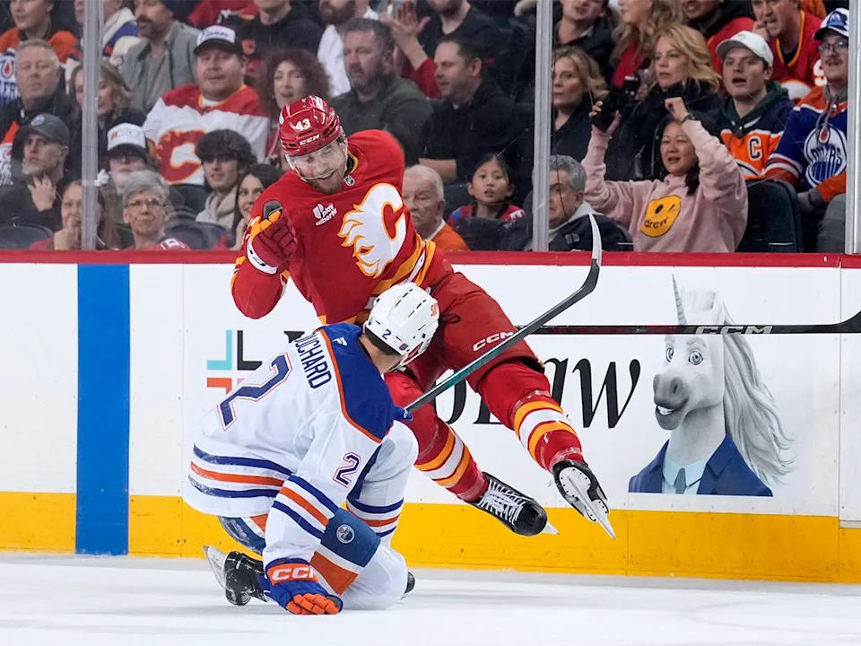  Adam Klapka #43 of the Calgary Flames and Evan Bouchard #2 of the Edmonton Oilers collide during the first period at the Scotiabank Saddledome on Dec. 27, 2025 in Calgary, Canada.