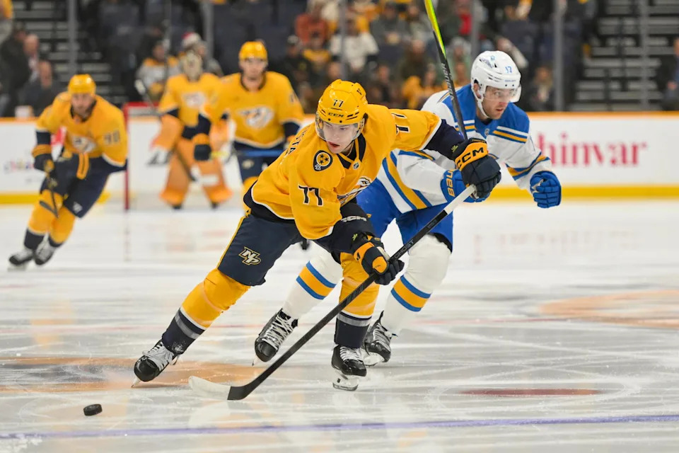 Dec 11, 2025; Nashville, Tennessee, USA; Nashville Predators right wing Luke Evangelista (77) skates with the puck against the St. Louis Blues during the first period at Bridgestone Arena. Mandatory Credit: Steve Roberts-Imagn Images