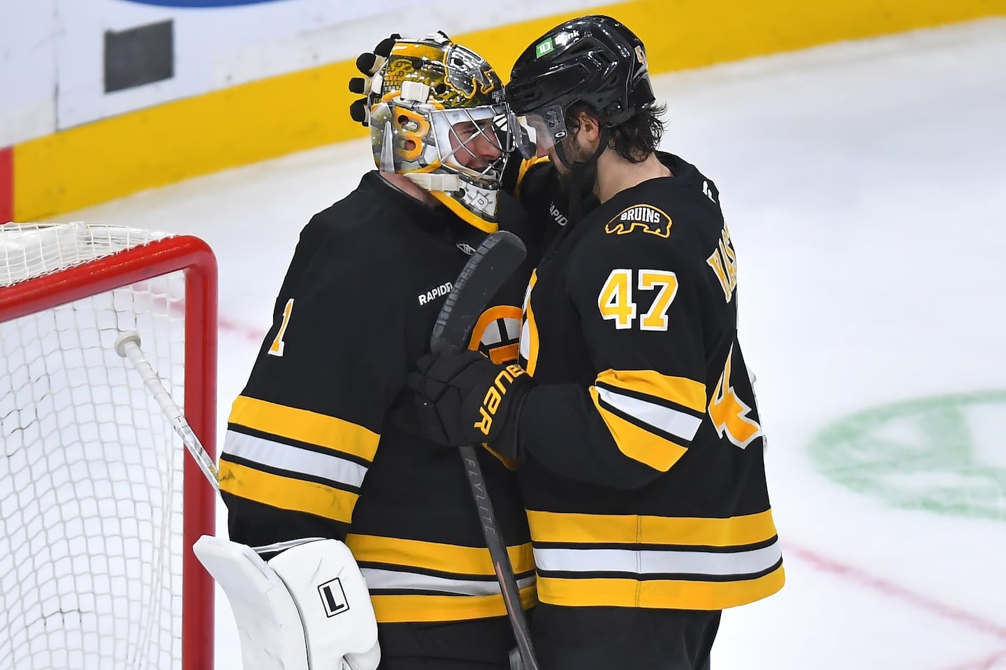 Bruins forward Mark Kastelic (47) celebrates with goaltender Jeremy Swayman after the 4-1 win over the Devils Saturday night at the Garden.