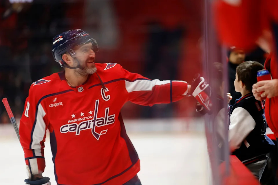Washington Capitals left wing Alex Ovechkin (8) fist-bumps his son after a game against the Toronto Maple Leafs.Geoff Burke-Imagn Images