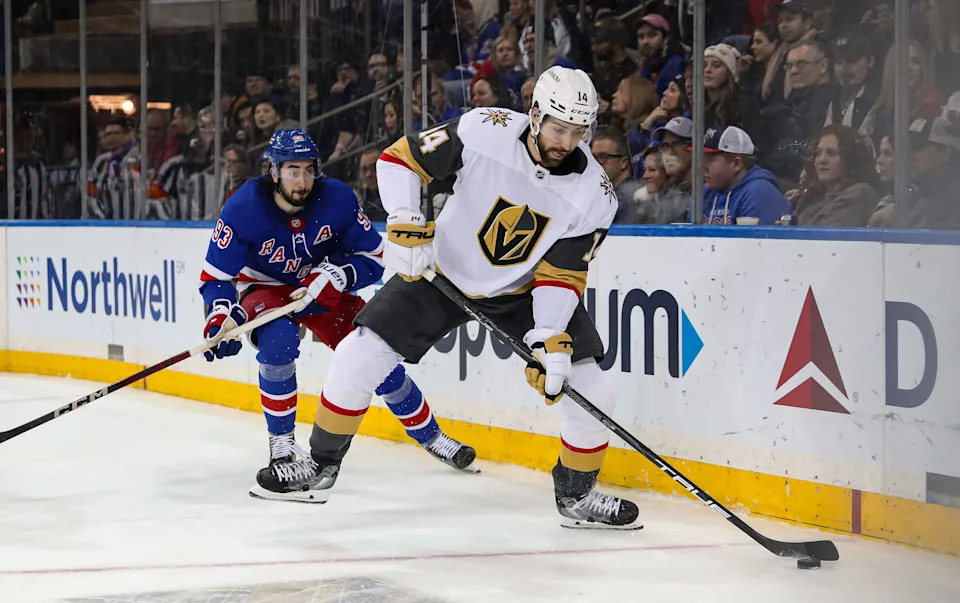 Feb 2, 2025; New York, New York, USA; Vegas Golden Knights defenseman Nicolas Hague (14) plays the puck in the corner while New York Rangers center Mika Zibanejad (93) chases after him during the second period at Madison Square Garden.
