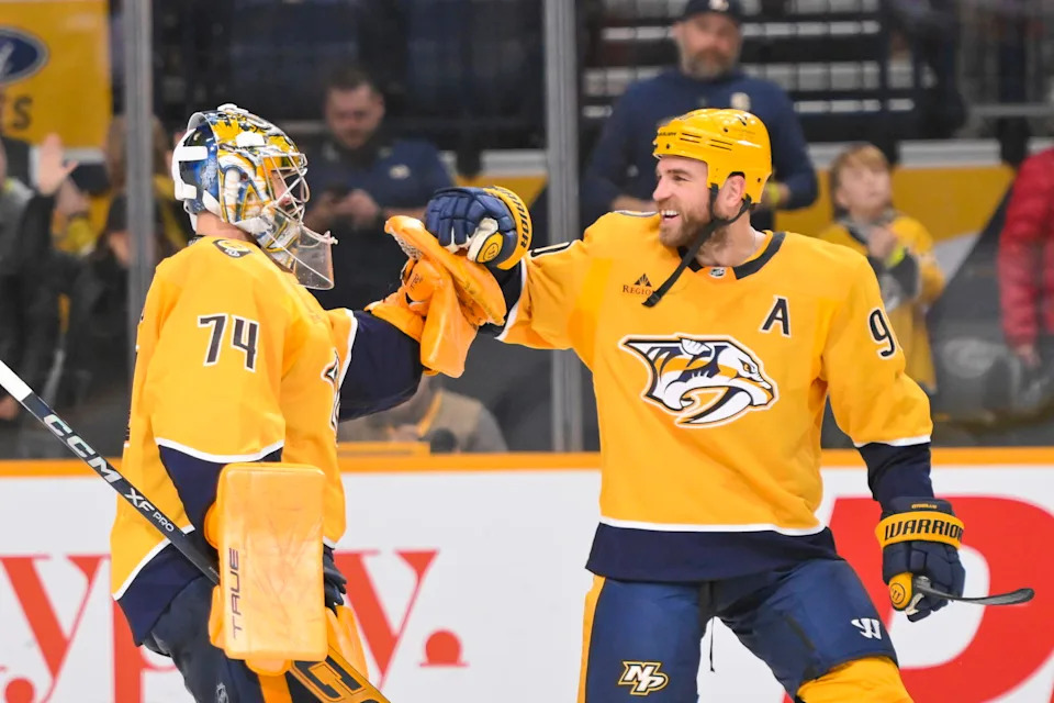 Dec 9, 2025; Nashville, Tennessee, USA; Nashville Predators center Ryan O'Reilly (90) celebrates with goaltender Juuse Saros (74) after defeating the Colorado Avalanche at Bridgestone Arena. Mandatory Credit: Steve Roberts-Imagn Images