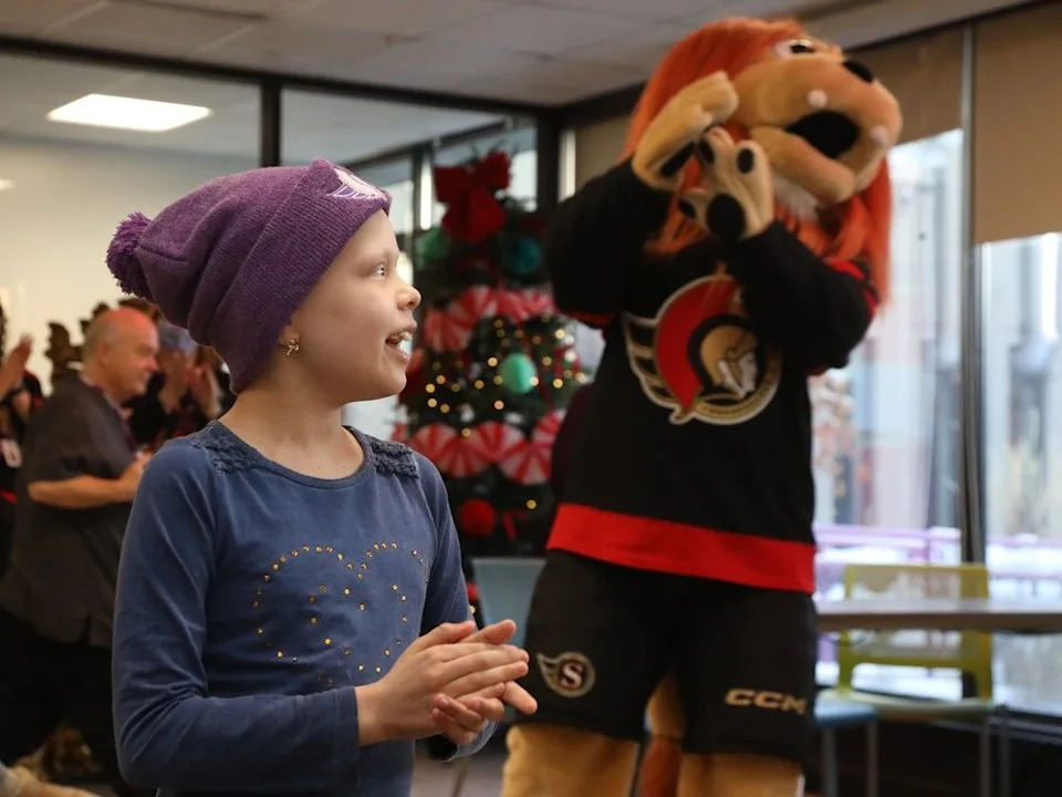  Charlotte Dow, 9 years old, was all smiles while listening to the Ottawa Senators sign Jingle Bells during their annual their annual trip to the Children’s Hospital of Eastern Ontario (CHEO) to spread festive cheer, December 08, 2025.