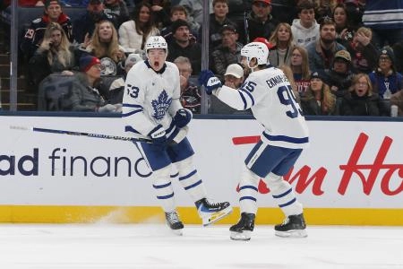 Easton Cowan celebrates a goal with Leafs teammate Oliver Ekman-Larsson