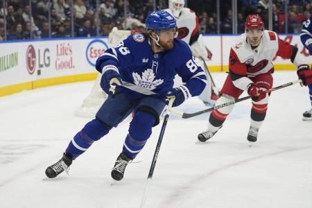 Nov 9, 2025; Toronto, Ontario, CAN; Toronto Maple Leafs forward William Nylander (88) and Carolina Hurricanes defenseman Sean Walker (26) chase after a puck during the first period at Scotiabank Arena.