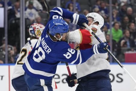 May 18, 2025; Toronto, Ontario, CAN; Florida Panthers defenseman Niko Mikkola (77) and Toronto Maple Leafs forward William Nylander (88) battle in front of the net during the third period of game seven of the second round of the 2025 Stanley Cup Playoffs at Scotiabank Arena. Mandatory Credit: John E. Sokolowski-Imagn Images