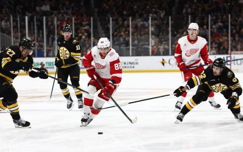Nov 29, 2025; Boston, Massachusetts, USA; Detroit Red Wings right wing Patrick Kane (88) splits between Boston Bruins defenseman Hampus Lindholm (27) and center Marat Khusnutdinov (92) during the second period at TD Garden. Mandatory Credit: Winslow Townson-Imagn Images