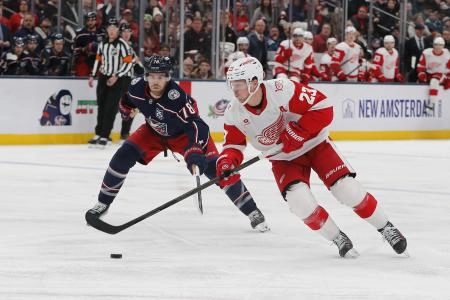 Dec 4, 2025; Columbus, Ohio, USA; Detroit Red Wings left wing Lucas Raymond (23) carries the puck as Columbus Blue Jackets defenseman Damon Severson (78) defends during the third period at Nationwide Arena. Dec 4, 2025; Columbus, Ohio, USA; Detroit Red Wings left wing Lucas Raymond (23) carries the puck as Columbus Blue Jackets defenseman Damon Severson (78) defends during the third period at Nationwide Arena.