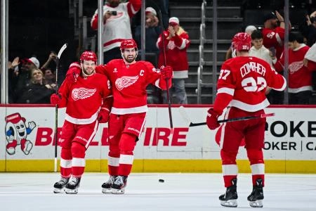 Apr 4, 2025; Detroit, Michigan, USA; Detroit Red Wings right wing Alex DeBrincat (93) celebrates his goal with center Dylan Larkin (71) and left wing J.T. Compher (37) during the third period against the Carolina Hurricanes at Little Caesars Arena. Apr 4, 2025; Detroit, Michigan, USA; Detroit Red Wings right wing Alex DeBrincat (93) celebrates his goal with center Dylan Larkin (71) and left wing J.T. Compher (37) during the third period against the Carolina Hurricanes at Little Caesars Arena.