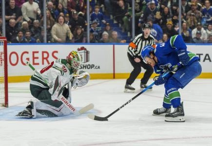 Dec 6, 2025; Vancouver, British Columbia, CAN; Vancouver Canucks left wing Kiefer Sherwood (44) on a breakaway against Minnesota Wild goalie Jesper Wallstedt (30) at Rogers Arena.