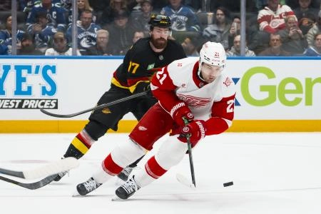 Dec 8, 2025; Vancouver, British Columbia, CAN; Vancouver Canucks defenseman Filip Hronek (17) defends against Detroit Red Wings forward James van Riemsdyk (21) in the second period at Rogers Arena.