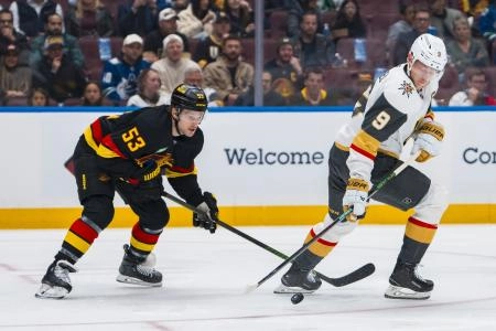 Apr 6, 2025; Vancouver, British Columbia, CAN; Vancouver Canucks forward Teddy Blueger (53) stick checks Vegas Golden Knights forward Jack Eichel (9) in the first period at Rogers Arena.