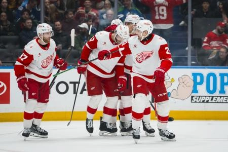 Dec 8, 2025; Vancouver, British Columbia, CAN; Detroit Red Wings defenseman Ben Chiarot (8) and forward Michael Rasmussen (27) and forward J.T. Compher (37) and forward James van Riemsdyk (21) celebrate Riemsdyk's goal against the Vancouver Canucks in the first period at Rogers Arena. Dec 8, 2025; Vancouver, British Columbia, CAN; Detroit Red Wings defenseman Ben Chiarot (8) and forward Michael Rasmussen (27) and forward J.T. Compher (37) and forward James van Riemsdyk (21) celebrate Riemsdyk's goal against the Vancouver Canucks in the first period at Rogers Arena.
