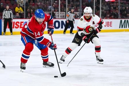 Dec 2, 2025; Montreal, Quebec, CAN; Montreal Canadiens center Nick Suzuki (14) plays the puck against Ottawa Senators right wing Claude Giroux (28) during the second period at Bell Centre. Mandatory Credit: David Kirouac-Imagn Images