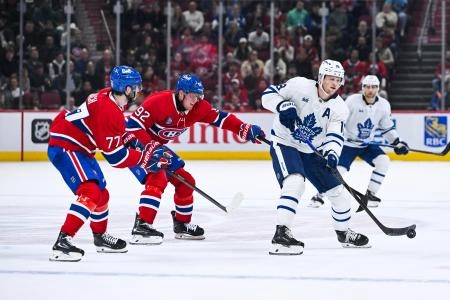 Sep 25, 2025; Montreal, Quebec, CAN; Toronto Maple Leafs forward Steven Lorentz (18) plays the puck against Montreal Canadiens right wing Patrik Laine (92) and center Kirby Dach (77) during the second period at Bell Centre. Mandatory Credit: David Kirouac-Imagn Images