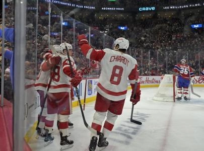 Dec 21, 2024; Montreal, Quebec, CAN; Detroit Red Wings forward Joe Veleno (90) celebrates with teammates including defenseman Jonatan Berggren (48) and defenseman Ben Chiarot (8) after scoring a goal against the Montreal Canadiens during the first period at the Bell Centre. Mandatory Credit: Eric Bolte-Imagn Images