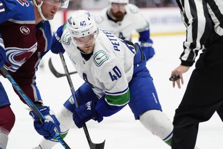 Dec 2, 2025; Denver, Colorado, USA; Vancouver Canucks center Elias Pettersson (40) takes a face off in the third period against the Colorado Avalanche at Ball Arena