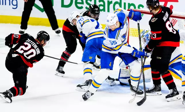 Ottawa Senators' Fabian Zetterlund (20) scores against St. Louis Blues goaltender Joel Hofer, seocnd from right, during third-period NHL hockey game action in Ottawa, Ontario, Saturday, Dec. 6, 2025. (Spencer Colby/The Canadian Press via AP)