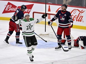 Dallas Stars' Roope Hintz (24) celebrates a goal by teammate Jason Robertson against the Winnipeg Jets during the third period of their NHL hockey game in Winnipeg, Tuesday, Dec. 9, 2025.