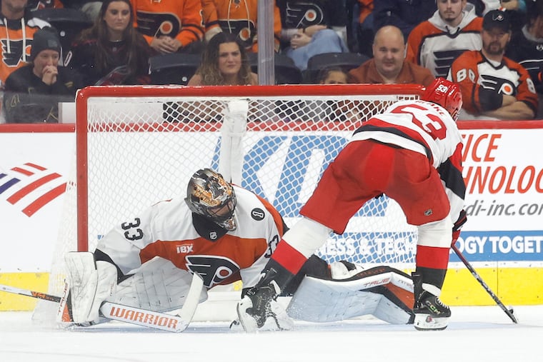 Flyers goaltender Samuel Ersson attempts to stop Carolina Hurricanes right wing Jackson Blake’s shootout game-winning goal on Saturday.