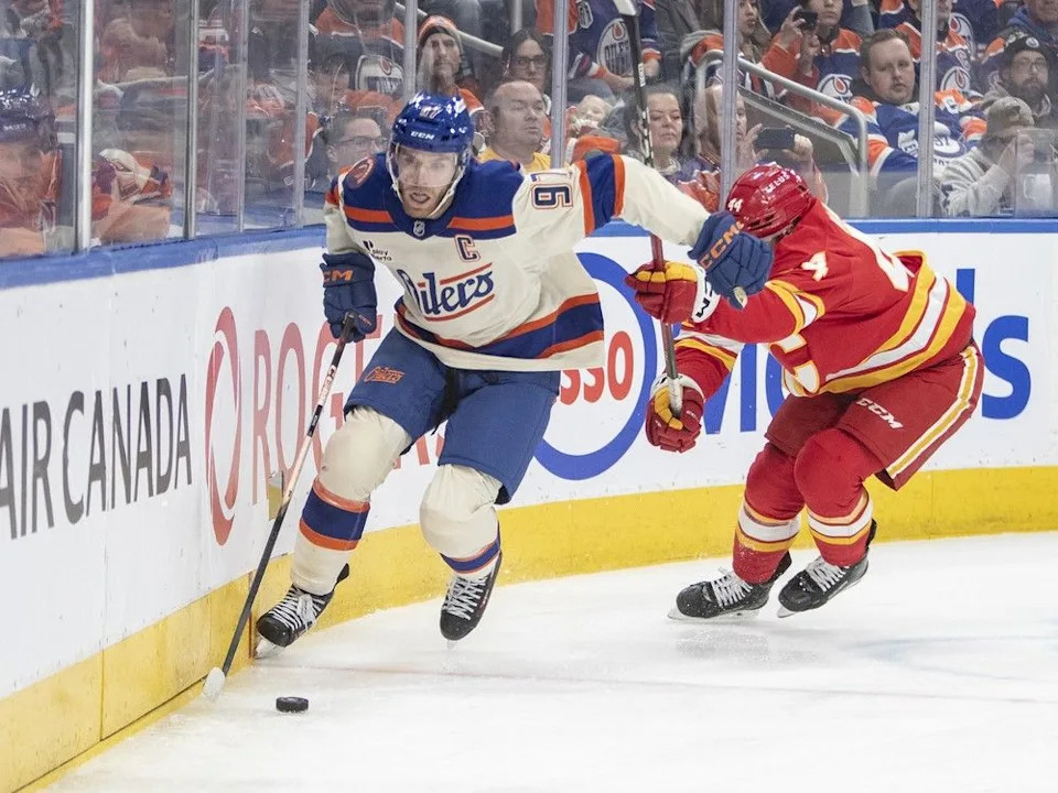  Calgary Flames’ Joel Hanley (44) chases Edmonton Oilers’ Connor McDavid (97) during second period NHL action in Edmonton on Tuesday, December 23, 2025.